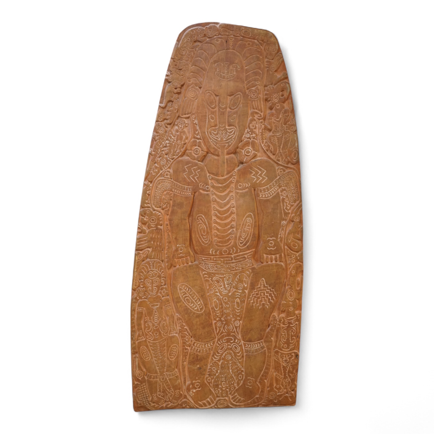 A Papua New Guinea Sepik River large wooden storyboard, relief carved and incised with a central figure surrounded by various animals and spirits, with traces of white pigment, 152cm high